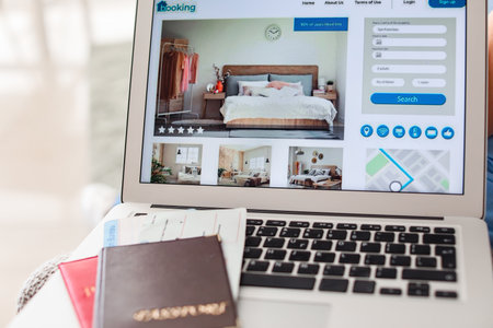 Open page of online booking service on screen of laptopの写真素材