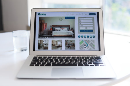 Open page of online booking service on screen of laptop on tableの写真素材