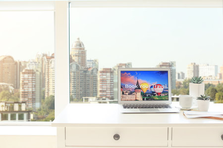 Open page of online booking service on screen of laptop on tableの写真素材