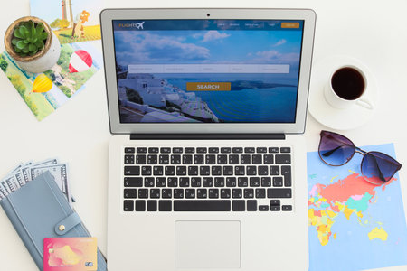 Open page of online booking service on screen of laptop on tableの写真素材