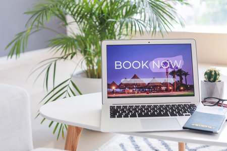Open page of online booking service on screen of laptop on tableの写真素材