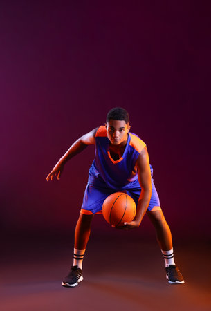 Young African-American basketball player on dark backgroundの写真素材