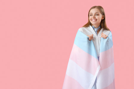 Young woman with transgender flag on pink backgroundのeditorial素材