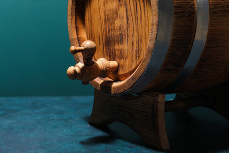 Wooden barrel on table near green wall, closeupの写真素材