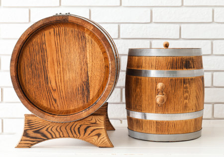 Wooden barrels on table near light brick wall