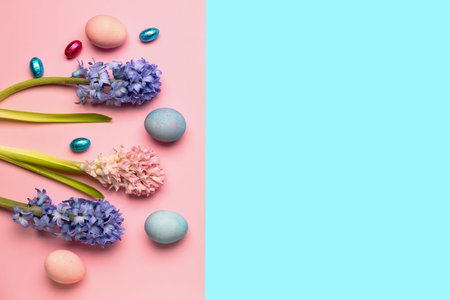 Composition with beautiful hyacinth flowers and Easter eggs on colorful background