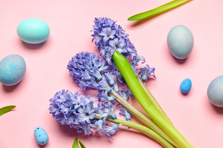 Beautiful hyacinth flowers and Easter eggs on pink backgroundの写真素材