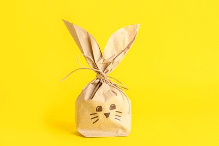 easter bunny gift bag on yellow backgroundの写真素材