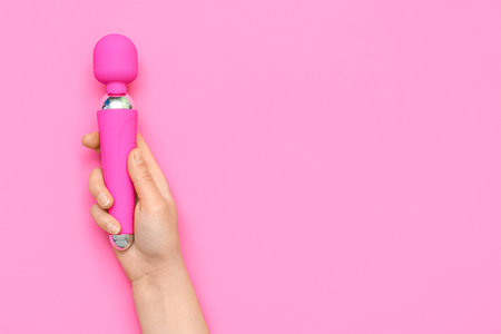 Woman with vibrator from sex shop on pink backgroundの写真素材
