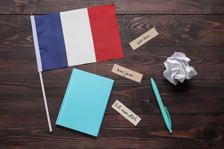 Flag of France with stationery and French words on dark wooden backgroundの写真素材