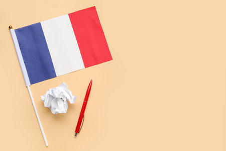Flag of France with pen and crumpled paper on beige backgroundの写真素材