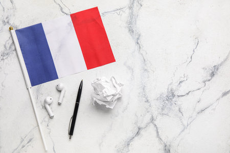 Flag of France with pen, earphones and crumpled paper on grunge backgroundの写真素材
