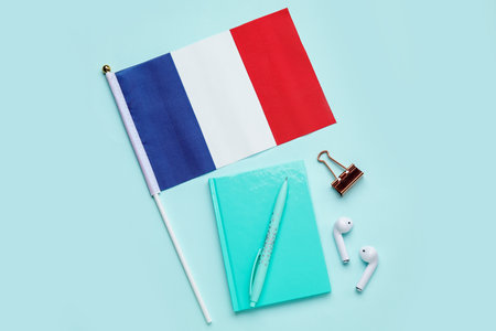 Flag of France with stationery and earphones on blue backgroundの写真素材