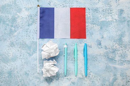 Flag of France with pens and crumpled paper on grunge backgroundの写真素材