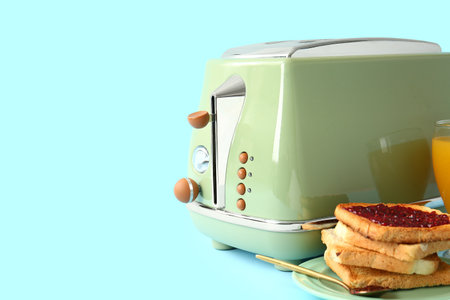 Modern toaster and toasts with jam on blue backgroundの写真素材