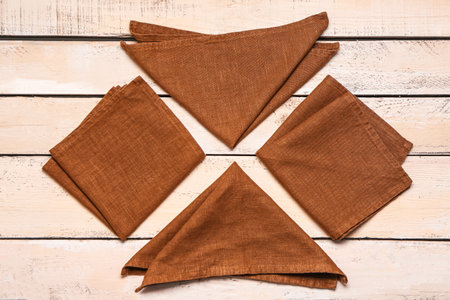 Composition with folded napkins on light wooden backgroundの写真素材