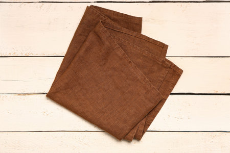Clean folded napkin on light wooden backgroundの写真素材