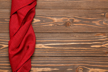 Red twisted napkin on wooden backgroundの写真素材
