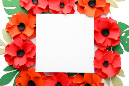 Blank paper sheet with poppy flowers and leaves on white backgroundの写真素材
