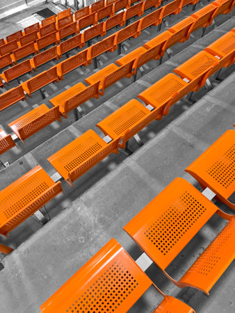 View of orange seats in stadiumの写真素材