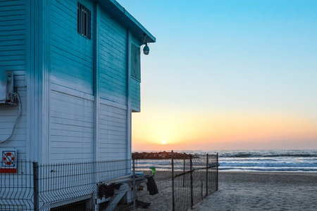 Lifeguard house on sea beach at sunset