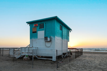 Lifeguard house on sea beach at sunsetの写真素材
