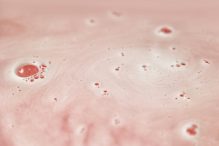Pink bath bomb dissolving in water, closeupの写真素材