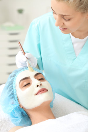 Young woman undergoing treatment in beauty salonの写真素材