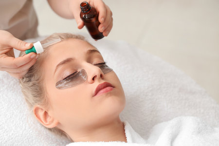 Young woman undergoing treatment in beauty salonの写真素材