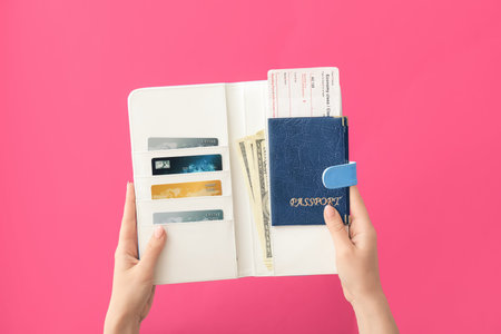 Female hands with travel organizer on color background