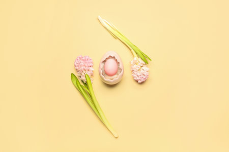 Composition with beautiful hyacinth flowers and Easter egg in decorative basket on beige backgroundの写真素材