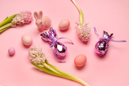 Beautiful hyacinth flowers, Easter eggs and bunny on pink backgroundの写真素材