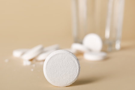 Soluble tablet on beige background, closeupの写真素材