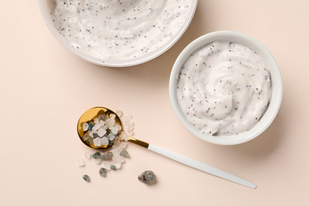 Bowl of natural body scrub and sea salt on color backgroundの写真素材