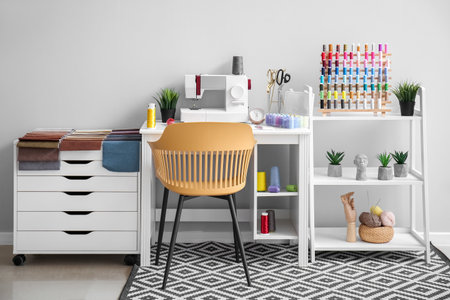 Interior of atelier with tailor's workplace, shelving unit and thread spoolsの写真素材