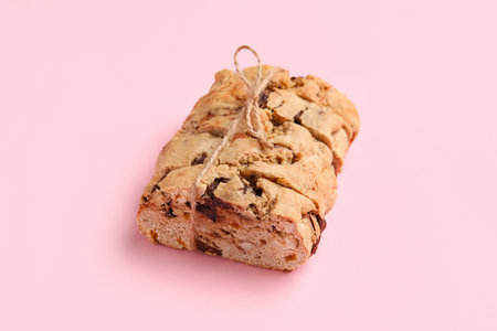 Delicious biscotti cookies tied with thread on pink backgroundの写真素材