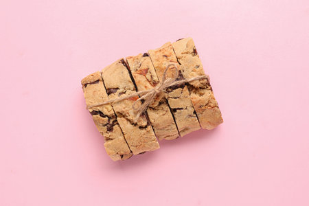 Delicious biscotti cookies tied with thread on pink backgroundの写真素材