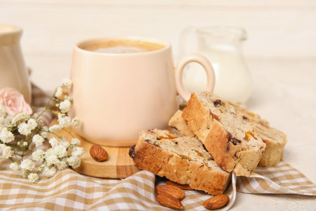 Delicious biscotti cookies, gypsophila flowers and cup of coffee on napkinの写真素材