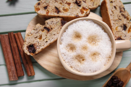 Delicious biscotti cookies and cup of coffee on green wooden backgroundの写真素材