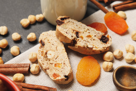 Delicious biscotti cookies, hazelnuts and dried apricots on napkin, closeupの写真素材