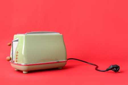 Modern toaster on red backgroundの写真素材