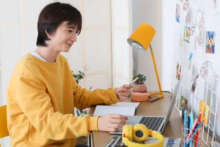 Male student studying online at homeの写真素材