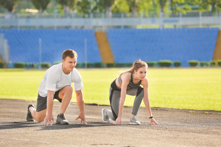 Sporty young couple training in the stadiumの写真素材