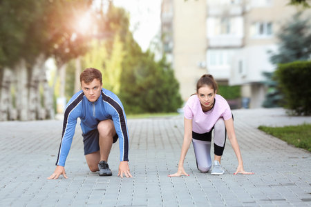 Sporty young couple training outdoors