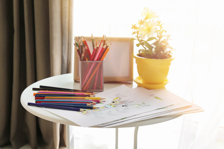 Coloring pictures and pencils on tableの写真素材