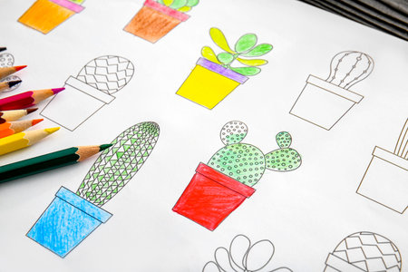 Coloring picture and pencils on table
