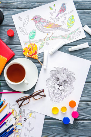 Composition with coloring pictures on tableの写真素材