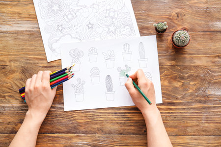 Woman coloring picture at tableの写真素材