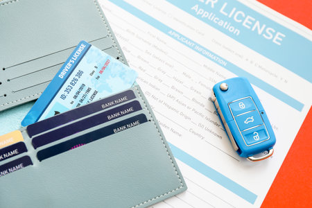 Driving license with wallet, application form and car key on color backgroundの写真素材