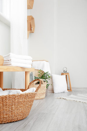 Bench and baskets with towels in the bathroomの写真素材